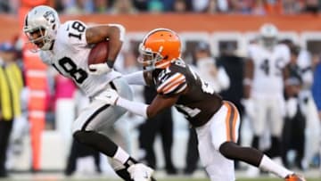 Oct 26, 2014; Cleveland, OH, USA; Oakland Raiders wide receiver Andre Holmes (18) makes a reception against Cleveland Browns cornerback Justin Gilbert (21) during the second quarter at FirstEnergy Stadium. Mandatory Credit: Ron Schwane-USA TODAY Sports