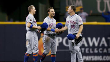 MILWAUKEE, WI - MAY 24: Brandon Nimmo #9, Michael Conforto #30, and Jay Bruce #19 of the New York Mets celebrate after beating the Milwaukee Brewers 5-0 at Miller Park on May 24, 2018 in Milwaukee, Wisconsin. (Photo by Dylan Buell/Getty Images)