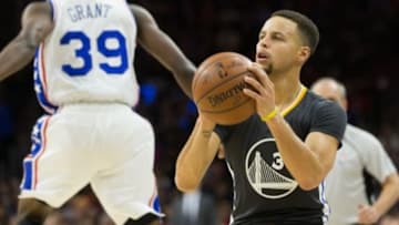 Jan 30, 2016; Philadelphia, PA, USA; Golden State Warriors guard Stephen Curry (30) looks to shoot after pump faking Philadelphia 76ers forward Jerami Grant (39) during the first quarter at Wells Fargo Center. Mandatory Credit: Bill Streicher-USA TODAY Sports