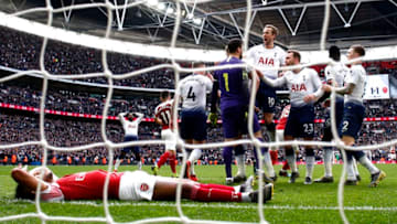 LONDON, ENGLAND - MARCH 02: Hugo Lloris of Tottenham Hotspur celebrates with teammates after saving a penalty whilst Pierre-Emerick Aubameyang of Arsenal looks dejected during the Premier League match between Tottenham Hotspur and Arsenal FC at Wembley Stadium on March 02, 2019 in London, United Kingdom. (Photo by Julian Finney/Getty Images)