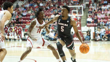 TUSCALOOSA, ALABAMA - FEBRUARY 26: Jermaine Couisnard #5 of the South Carolina Gamecocks looks to maneuver the ball by Keon Ellis #14 of the Alabama Crimson Tide at Coleman Coliseum on February 26, 2022 in Tuscaloosa, Alabama. (Photo by Michael Chang/Getty Images)