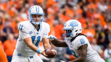 SYRACUSE, NY - OCTOBER 20: Nathan Elliott #11 hands the ball off to Michael Carter #8 of the North Carolina Tar Heels during the second half against the Syracuse Orange at the Carrier Dome on October 20, 2018 in Syracuse, New York. Syracuse defeats North Carolina in overtime 40-37. (Photo by Brett Carlsen/Getty Images)