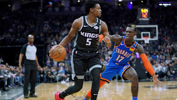 SACRAMENTO, CALIFORNIA - JANUARY 29: De'Aaron Fox #5 of the Sacramento Kings dribbles the ball past Dennis Schroder #17 of the Oklahoma City Thunder during the first half of an NBA Basketball game at Golden 1 Center on January 29, 2020 in Sacramento, California. NOTE TO USER: User expressly acknowledges and agrees that, by downloading and or using this photograph, User is consenting to the terms and conditions of the Getty Images License Agreement. (Photo by Thearon W. Henderson/Getty Images)