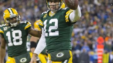 Dec 28, 2014; Green Bay, WI, USA; Green Bay Packers quarterback Aaron Rodgers (12) celebrates after scoring a touchdown during the fourth quarter against the Detroit Lions at Lambeau Field. Green Bay won 30-20. Mandatory Credit: Jeff Hanisch-USA TODAY Sports