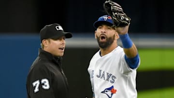Apr 21, 2015; Toronto, Ontario, CAN; Toronto Blue Jays right fielder Jose Bautista (19) is restrained by second base umpire Tripp Gibson (73) as he engages in a verbal altercation with Baltimore Orioles players prior to the eighth inning at Rogers Centre. The Blue Jays won 13-6. Mandatory Credit: Dan Hamilton-USA TODAY Sports