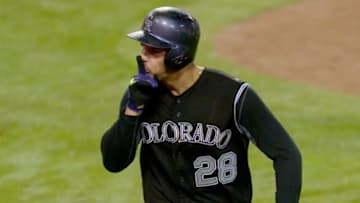 Sep 15, 2015; Los Angeles, CA, USA; Colorado Rockies third baseman Nolan Arenado (28) heads to the dugout after hitting a solo home run in the sixteenth inning of the game off Los Angeles Dodgers relief pitcher Mat Latos (not pictured) at Dodger Stadium. Rockies won 5-4. Mandatory Credit: Jayne Kamin-Oncea-USA TODAY Sports