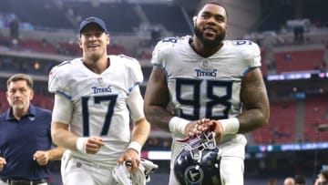 HOUSTON, TEXAS - JANUARY 09: Ryan Tannehill #17 and Jeffery Simmons #98 of the Tennessee Titans react as they head to the locker room after Tennessee defeated the Houston Texans 28-25 at NRG Stadium on January 09, 2022 in Houston, Texas. (Photo by Tim Warner/Getty Images)