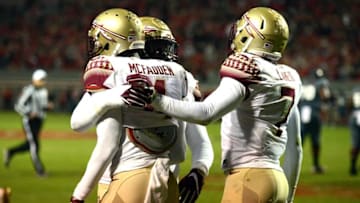 Nov 5, 2016; Raleigh, NC, USA; Florida State Seminoles defensive back Tarvarus McFadden (4) is congratulated by teammates after an interception during the first half against the North Carolina State Wolfpack at Carter Finley Stadium. Mandatory Credit: Rob Kinnan-USA TODAY Sports