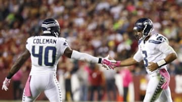 Oct 6, 2014; Landover, MD, USA; Seattle Seahawks quarterback Russell Wilson (3) celebrates with fullback Derrick Coleman (40) after scoring a touchdown against the Washington Redskins in the second quarter at FedEx Field. Mandatory Credit: Geoff Burke-USA TODAY Sports