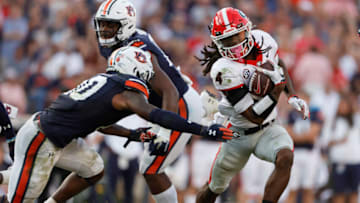 Auburn footballOct 9, 2021; Auburn, Alabama, USA; Georgia Bulldogs running back James Cook avoids the tackle of Auburn Tigers safety Zion Puckett (10) during the fourth quarter Jordan-Hare Stadium. Mandatory Credit: John Reed-USA TODAY Sports