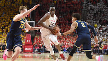 COLLEGE PARK, MD - MARCH 03: Jalen Smith #25 of the Maryland Terrapins drives to the basket through Ignas Brazdeikis #13 and Jordan Poole #2 of the Michigan Wolverines in the second half during a college basketball game against the Michigan Wolverines at the XFinity Center on March 3, 2019 in College Park, Maryland. (Photo by Mitchell Layton/Getty Images)
