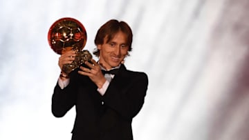 TOPSHOT - Real Madrid's Croatian midfielder Luka Modric brandishes the trophy after receiving the 2018 FIFA Men's Ballon d'Or award for best player of the year during the 2018 FIFA Ballon d'Or award ceremony at the Grand Palais in Paris on December 3, 2018. - The winner of the 2018 Ballon d'Or will be revealed at a glittering ceremony in Paris on December 3 evening, with Croatia's Luka Modric and a host of French World Cup winners all hoping to finally end the 10-year duopoly of Cristiano Ronaldo and Lionel Messi. (Photo by FRANCK FIFE / AFP) (Photo credit should read FRANCK FIFE/AFP/Getty Images)