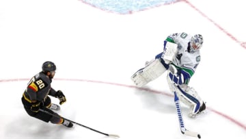 Jacob Markstrom #25 of the Vancouver Canucks clears the puck away from Chandler Stephenson #20 of the Vegas Golden Knights during the first period in Game Two of the Western Conference Second Round. (Photo by Bruce Bennett/Getty Images)
