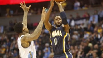 Dec 20, 2014; Denver, CO, USA; Indiana Pacers guard C.J. Miles (0) shoots the ball over Denver Nuggets forward Wilson Chandler (21) during the first half at Pepsi Center. Mandatory Credit: Chris Humphreys-USA TODAY Sports