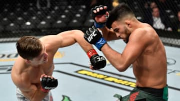 LAS VEGAS, NEVADA - JANUARY 18: (L-R) Drew Dober punches Nasrat Haqparast of Germany in their lightweight fight during the UFC 246 event at T-Mobile Arena on January 18, 2020 in Las Vegas, Nevada. (Photo by Jeff Bottari/Zuffa LLC via Getty Images)