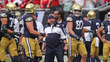 CHICAGO, ILLINOIS - SEPTEMBER 25: Head coach Brian Kelly talks to members of his team after a turnover against the Wisconsin Badgers at Soldier Field on September 25, 2021 in Chicago, Illinois. Notre Dame defeated Wisconsin 41-13. (Photo by Jonathan Daniel/Getty Images)