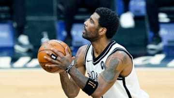 SACRAMENTO, CALIFORNIA - FEBRUARY 15: Kyrie Irving #11 of the Brooklyn Nets stands at the line to shoot a foul shot against the Sacramento Kings during the first half of an NBA basketball game at Golden 1 Center on February 15, 2021 in Sacramento, California. NOTE TO USER: User expressly acknowledges and agrees that, by downloading and or using this photograph, User is consenting to the terms and conditions of the Getty Images License Agreement. (Photo by Thearon W. Henderson/Getty Images)