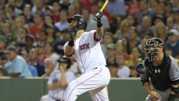 Jul 8, 2014; Boston, MA, USA; Boston Red Sox first baseman Mike Napoli (12) hits an RBI double during the fifth inning against the Chicago White Sox at Fenway Park. Mandatory Credit: Bob DeChiara-USA TODAY Sports