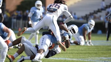 Oct 24, 2015; Chapel Hill, NC, USA; North Carolina Tar Heels running back Elijah Hood (34) is tackled by Virginia Cavaliers safety Quin Blanding (3) and cornerback Maurice Canady (26) in the first quarter at Kenan Memorial Stadium. Mandatory Credit: Bob Donnan-USA TODAY Sports