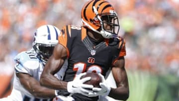 Sep 21, 2014; Cincinnati, OH, USA; Cincinnati Bengals wide receiver A.J. Green (18) catches a pass against Tennessee Titans cornerback Jason McCourty (30) in the first half at Paul Brown Stadium. Cincinnati defeated Tennessee 33-7. Mandatory Credit: Mark Zerof-USA TODAY Sports