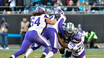 CHARLOTTE, NC - DECEMBER 10: Xavier Rhodes #29 of the Minnesota Vikings tackles Jonathan Stewart #28 of the Carolina Panthers during their game at Bank of America Stadium on December 10, 2017 in Charlotte, North Carolina. (Photo by Grant Halverson/Getty Images)