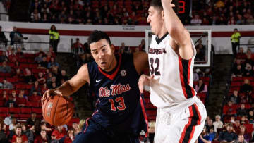 Feb 27, 2016; Athens, GA, USA; Mississippi Rebels forward Anthony Perez (13) dribbles past Georgia Bulldogs forward Mike Edwards (32) during the first half at Stegeman Coliseum. Mandatory Credit: Dale Zanine-USA TODAY Sports