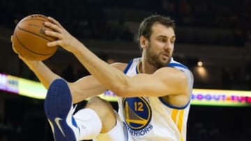 Mar 14, 2014; Oakland, CA, USA; Golden State Warriors center Andrew Bogut (12) controls a rebound against the Cleveland Cavaliers during the second quarter at Oracle Arena. Mandatory Credit: Kelley L Cox-USA TODAY Sports