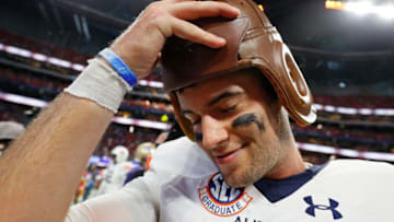 Jarrett Stidham tired on the Old Leather Helmet trophy last week after Auburn defeated Washington. (Photo by Kevin C. Cox/Getty Images)