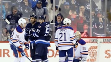 Dec 3, 2014; Winnipeg, Manitoba, CAN; Winnipeg Jets forward Dustin Byfuglien (33) celebrates after he scores on Edmonton Oilers goalie Ben Scrivens (30) during the third period at MTS Centre. Winnipeg wins in overtime 3-2. Mandatory Credit: Bruce Fedyck-USA TODAY Sports