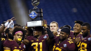 Dec 28, 2015; Detroit, MI, USA; Minnesota Golden Gophers defensive back Eric Murray (31) holds up the trophy after winning the Quick Lane Bowl against the Central Michigan Chippewas at Ford Field. Minnesota won 21-14. Mandatory Credit: Sage Osentoski-USA TODAY Sports