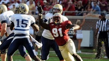 Sep 10, 2011; Tallahassee, FL, USA; Florida State Seminoles defensive end Cornellius Carradine (91) puts pressure on Charleston Southern Buccaneers quarterback Malcom Dixon (15) during the first half at Doak Campbell Stadium. Mandatory Credit: Melina Vastola-USA TODAY Sports