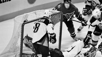 06/04/98 - Caps vs Sabres. Caps Joe Juneau (C) watches from the side of the goal as his overtime shot goes past the Sabre goalie Dominik Hasek and into the net for the victory. Sabres Darryl Shannon(8) and Mike Wilson(R) watch. - Photo By Rich Lipski TWP (Photo by Rich Lipski/The Washington Post/Getty Images)