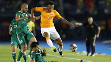 Ivory Coast's midfielder Jean-Philippe Gbamin (R) fights for the ball with Algeria's midfielder Sofiane Feghouli during the 2019 Africa Cup of Nations (CAN) quarter final football match between Ivory Coast and Algeria at the Suez stadium in Suez on July 11, 2019. (Photo by FADEL SENNA / AFP) (Photo credit should read FADEL SENNA/AFP via Getty Images)