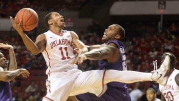 Feb 2, 2016; Norman, OK, USA; Oklahoma Sooners guard Isaiah Cousins (11) shoots the ball in front of TCU Horned Frogs forward Devonta Abron (23) during the second half at Lloyd Noble Center. Mandatory Credit: Mark D. Smith-USA TODAY Sports