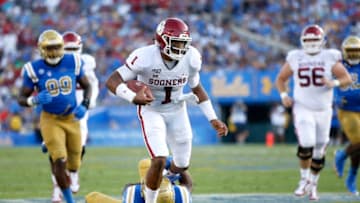 LOS ANGELES, CALIFORNIA - SEPTEMBER 14: Jalen Hurts #1 of the Oklahoma Sooners runs over Stephan Blaylock #4 of the UCLA Bruins during the first half of a game on at the Rose Bowl on September 14, 2019 in Los Angeles, California. (Photo by Sean M. Haffey/Getty Images)