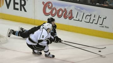 May 26, 2013; San Jose, CA, USA; San Jose Sharks center Logan Couture (39, back) dives for the puck against Los Angeles Kings defenseman Drew Doughty (8) during the third period in game six of the second round of the 2013 Stanley Cup Playoffs at HP Pavilion. The Sharks defeated the Kings 2-1. Mandatory Credit: Kyle Terada-USA TODAY Sports