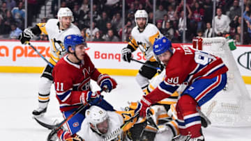 MONTREAL, QC - OCTOBER 13: Brendan Gallagher #11 of the Montreal Canadiens and teammate Tomas Tatar #90 hold down Bryan Rust #17 of the Pittsburgh Penguins during the NHL game at the Bell Centre on October 13, 2018 in Montreal, Quebec, Canada. The Montreal Canadiens defeated the Pittsburgh Penguins 4-3 in a shootout. (Photo by Minas Panagiotakis/Getty Images)