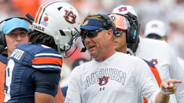 Auburn football head coach Hugh Freeze talks with quarterback Robby Ashford (9) on the sidelines during the UMass game at Jordan-Hare Stadium on the Auburn University campus in Auburn, Ala., on Saturday September 2, 2023.
