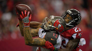 Sep 11, 2016; Atlanta, GA, USA; Tampa Bay Buccaneers wide receiver Mike Evans (13) catches a touchdown pass in front of Atlanta Falcons cornerback Robert Alford (23) during the second half at the Georgia Dome. The Buccaneers won 31-24. Mandatory Credit: Dale Zanine-USA TODAY Sports
