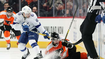 PHILADELPHIA, PA - FEBRUARY 19: Travis Sanheim #6 of the Philadelphia Flyers falls to the ice while battling for the loose puck along the boards with Danick Martel #62 of the Tampa Bay Lightning on February 19, 2019 at the Wells Fargo Center in Philadelphia, Pennsylvania. (Photo by Len Redkoles/NHLI via Getty Images)