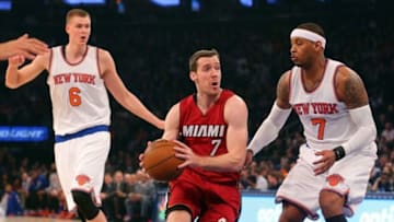 Feb 28, 2016; New York, NY, USA; Miami Heat point guard Goran Dragic (7) drives between New York Knicks small forward Carmelo Anthony (7) and New York Knicks power forward Kristaps Porzingis (6) during the first quarter at Madison Square Garden. Mandatory Credit: Brad Penner-USA TODAY Sports