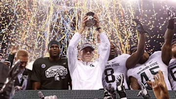 Dec 5, 2015; Indianapolis, IN, USA; Michigan State Spartans head coach Mark Dantonio celebrates with his team after defeating the Iowa Hawkeyes in the Big Ten Conference football championship game at Lucas Oil Stadium. Mandatory Credit: Brian Spurlock-USA TODAY Sports