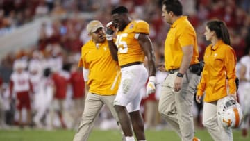 JACKSONVILLE, FL - JANUARY 02: Daniel Bituli #35 of the Tennessee Volunteers is helped off the field after suffering an injury during the TaxSlayer Gator Bowl against the Indiana Hoosiers at TIAA Bank Field on January 2, 2020 in Jacksonville, Florida. Tennessee defeated Indiana 23-22. (Photo by Joe Robbins/Getty Images)