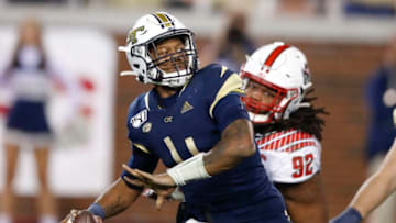 ATLANTA, GA - NOVEMBER 21: James Graham #4 of the Georgia Tech Yellow Jackets is pressured by Larrell Murchison #92 of the North Carolina State Wolfpack during the second half at Bobby Dodd Stadium on November 21, 2019 in Atlanta, Georgia. (Photo by Todd Kirkland/Getty Images)