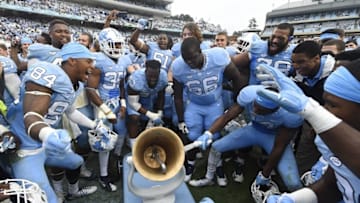 Nov 7, 2015; Chapel Hill, NC, USA; North Carolina Tar players celebrate with the Victory Bell after the game. The Tar Heels defeated the Blue Devils 66-31 at Kenan Memorial Stadium. Mandatory Credit: Bob Donnan-USA TODAY Sports