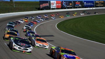 KANSAS CITY, KS - OCTOBER 22: Kyle Busch, driver of the #18 M&M's Halloween Toyota, and Kevin Harvick, driver of the #4 Jimmy John's Ford, lead the field to green during a restart during the Monster Energy NASCAR Cup Series Hollywood Casino 400 at Kansas Speedway on October 22, 2017 in Kansas City, Kansas. (Photo by Chris Trotman/Getty Images)