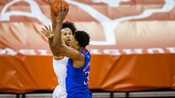 Feb 23, 2021; Austin, Texas, USA; Texas Longhorns forward Jericho Sims (20) blocks Kansas Jayhawks forward David McCormack (33) shot in the first half of an NCAA college basketball game at the Frank Erwin Center. Mandatory Credit: Ricardo B. Brazziell/American-Statesman-USA TODAY Sports