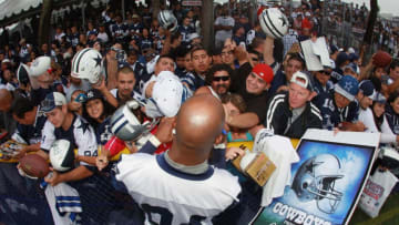 OXNARD, CA - AUGUST 14: Wide receiver Patrick Crayton #84 signs autographs for fans during Dallas Cowboys Training Camp at the Marriott Residence Inn Oxnard River Ridge on August 14, 2010 in Oxnard, California. (Photo by Jeff Gross/Getty Images)