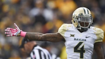 Oct 18, 2014; Morgantown, WV, USA; Baylor Bears cornerback Xavien Howard (4) signals they had recovered the fumble during the first quarter against the West Virginia Mountaineers at Milan Puskar Stadium. Mandatory Credit: Tommy Gilligan-USA TODAY Sports
