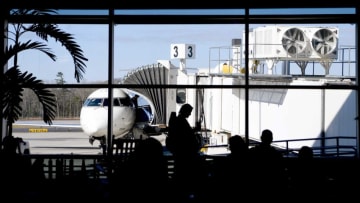 Travelers wait for their flights at the gate as passengers disembark from a plane at the Asheville Regional Airport on March 27, 2019.Asheville Airport 001